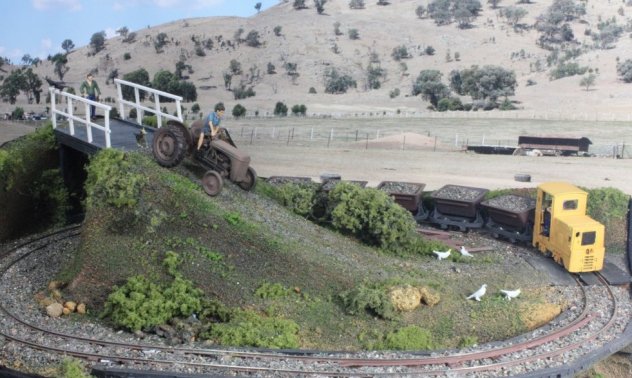 Ruston # 6 slowly crosses the level crossing as the approaching farmer slows his tractor.