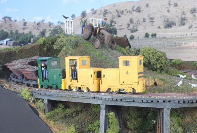 The peace for four Cockatoos feeding on grass seed, is about to be disturbed as Ruston’s numbers 4, 5 and 6  (KB Scale models) approach with a ballast train, and the farmer on his tractor is heading down the hill. 